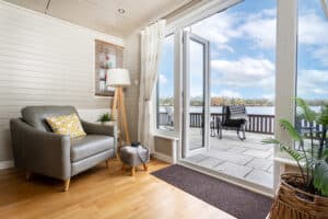 Armchair by the patio doors overlooking the lake at Keer Lodge