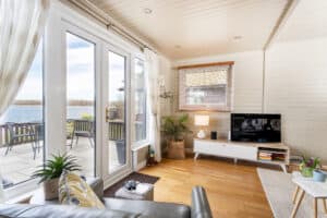 Open-plan lounge with patio doors to the lakeside terrace at Keer Lodge