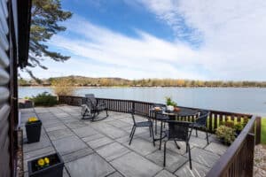 Private lakeside terrace with table and chairs at Keer Lodge