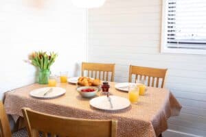 Dining area for four with high chair available at Sandmartin Lodge