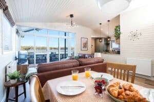 Breakfast table with a view of the lake at Sandmartin Lodge