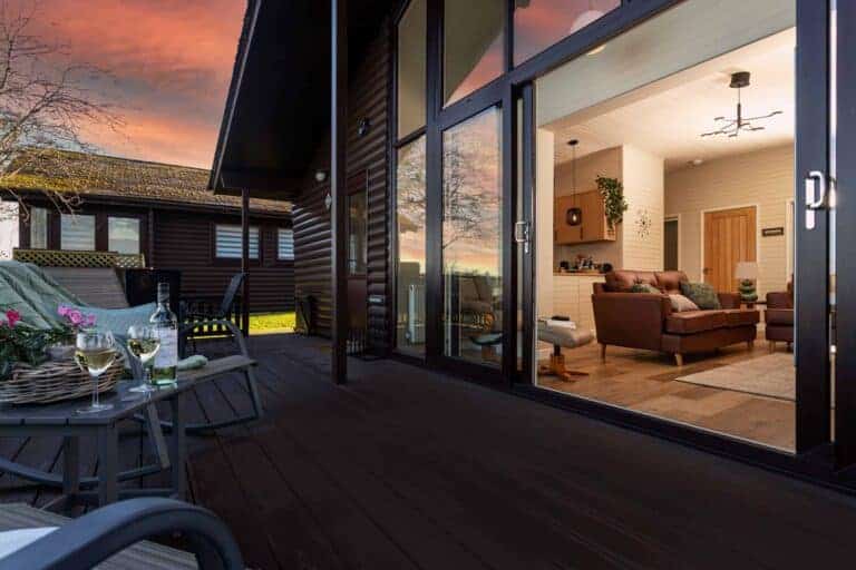 Open plan living opening onto the lakeside terrace at Sandmartin Lodge