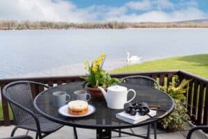 Tea and cake on the lakeside terrace at Keer Lodge