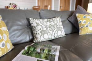 Leather sofa with patterned cushions at Keer Lodge