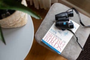 Binoculars and bird book for spotting wildlife on the lake at Keer Lodge