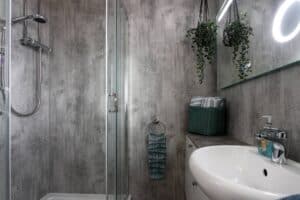 Walk-in rain shower and basin at Keer Lodge